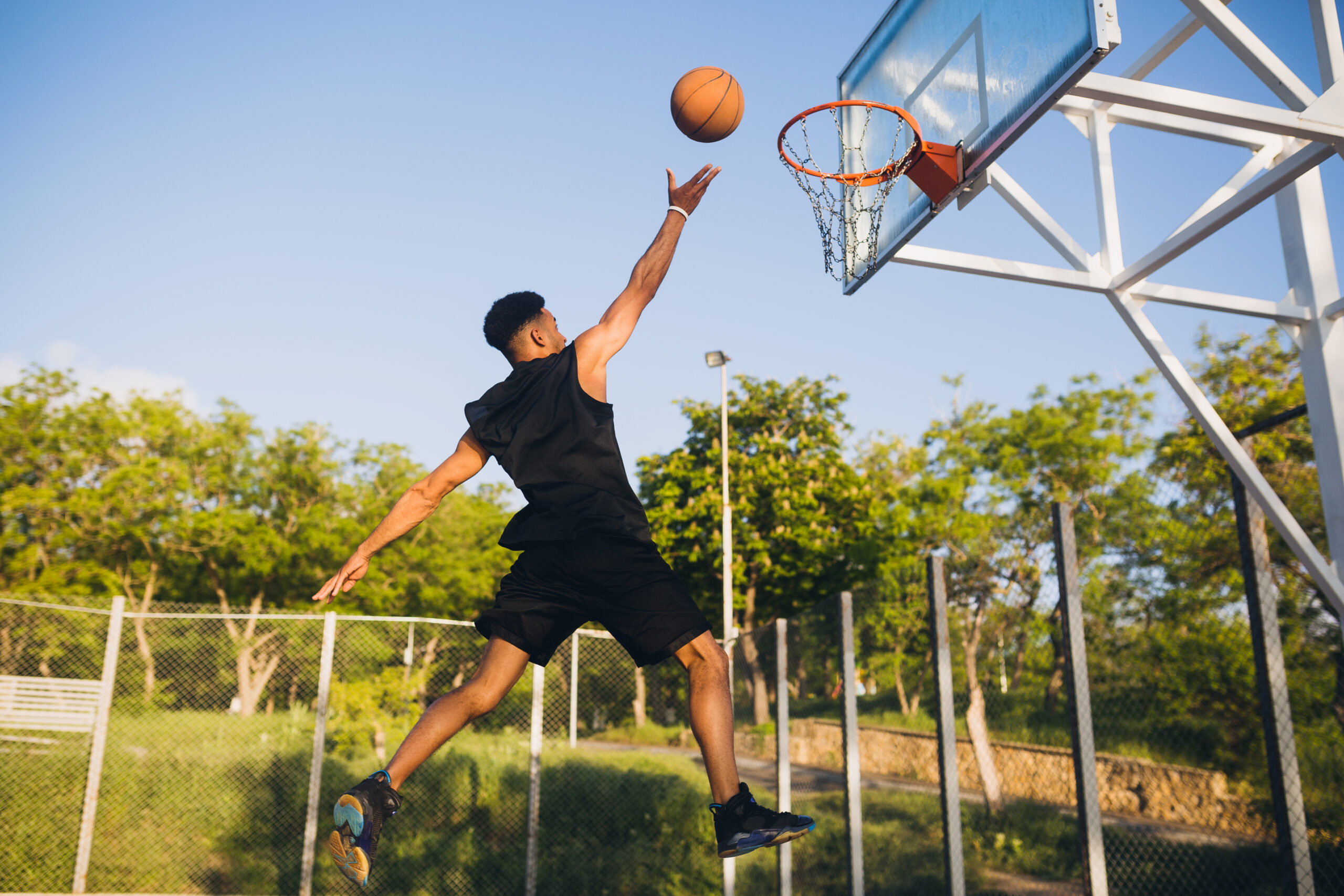 cool-black-man-doing-sports-playing-basketball-sunrise-jumping-scaled-1.jpg