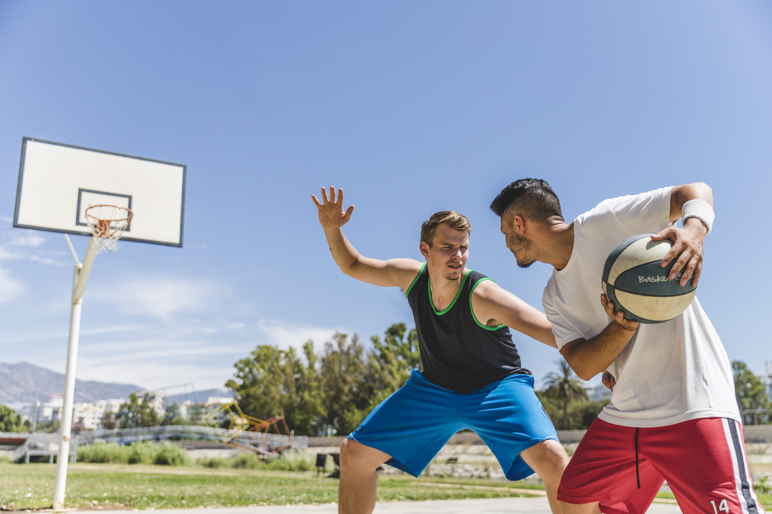 young-male-player-playing-with-basketball-player-scaled-1.jpg